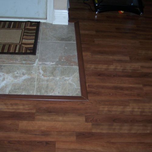 Laminate wood floor and marble tile with T mold