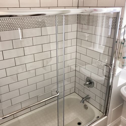 Shower tile and framed shower door install.