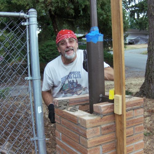 My self building a brick column for a driveway gat