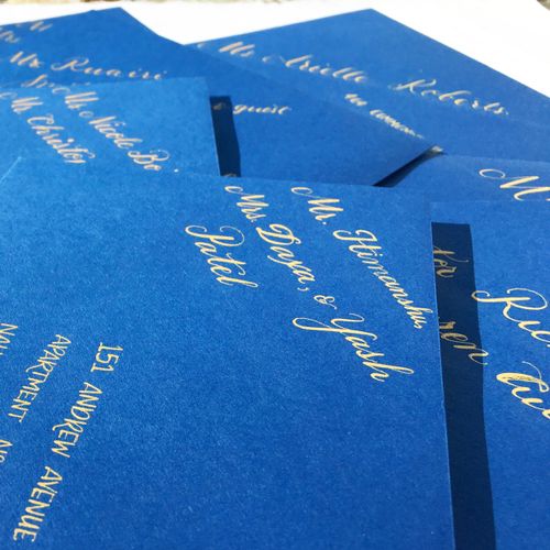 Gold calligraphy ink on navy envelopes