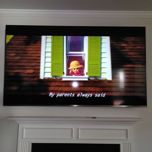 65" Flat panel mounted above the fireplace. Reside