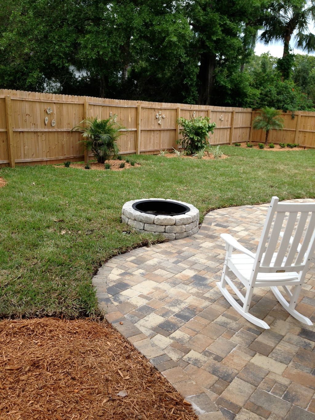 Nice little patio with firepit, new sod and some f