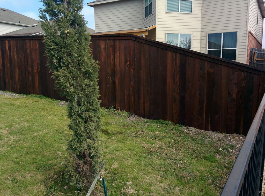 Prestained residential wood fence with cap & trim 