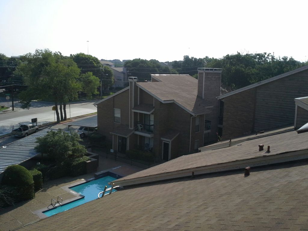 Cleaning gutters at an apartment complex.