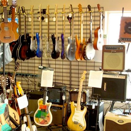 The guitar wall. We have sheet music and amps too!
