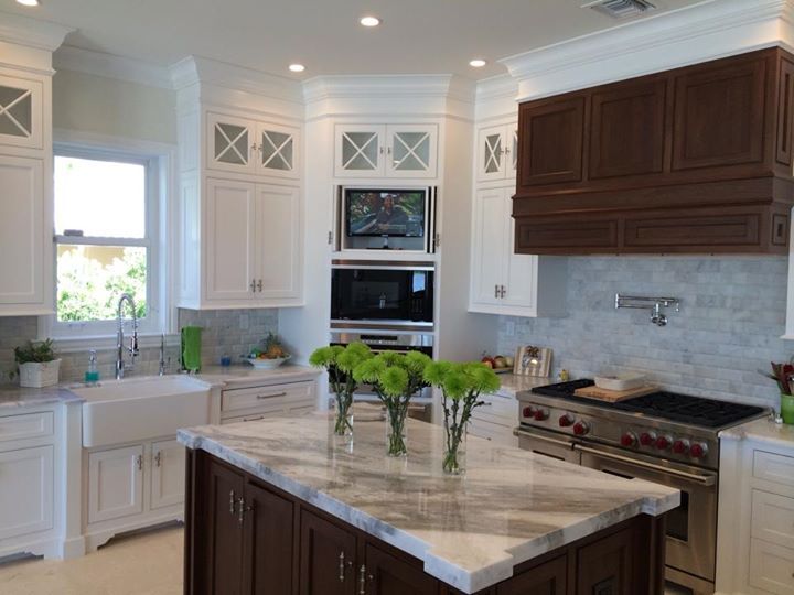 Samsung TV in kitchen with hide away cabinet doors