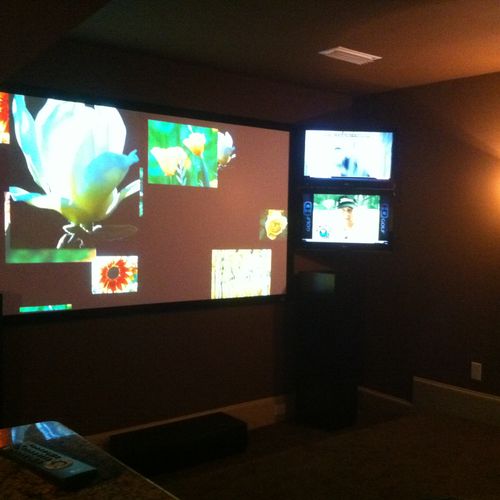 120 Screen with 2, 42inch Tv's in a media room.