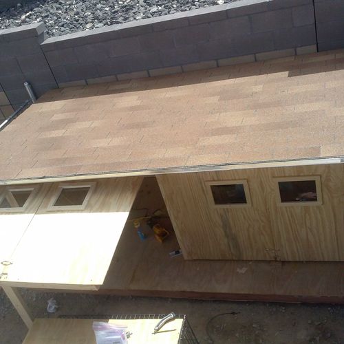 Front side of a custom built dog house.