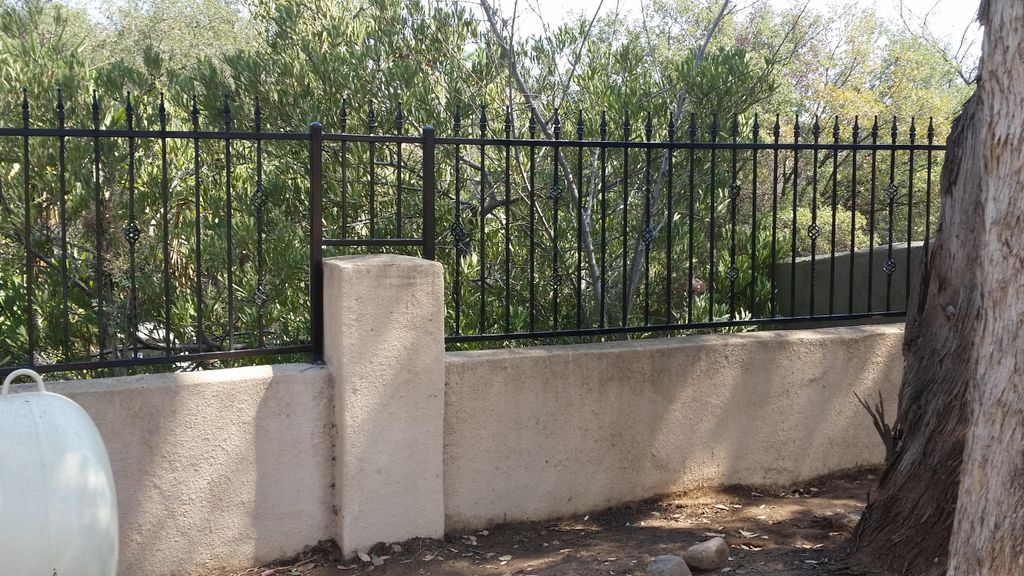 Iron on top of a wall for added security.