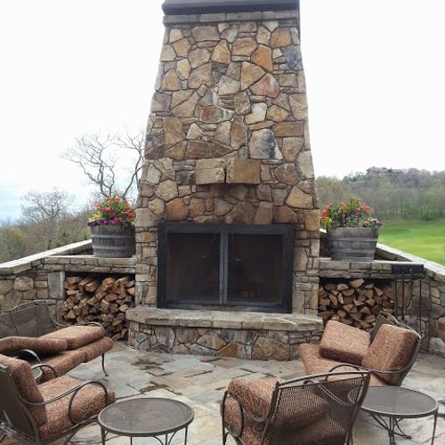 Outdoor fireplace with wood storage