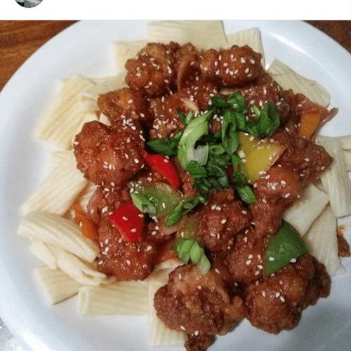 Chilli chicken pasta with sesame seeds on top with