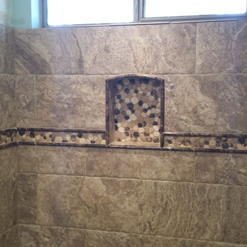 Shower Remodel. Tile, decorative strip, and a rece