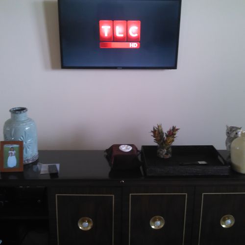 TV mounted with all wires concealed. Equipment is 