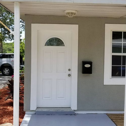 Fresh door, trim and siding paint on a recent flip