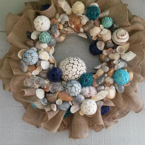 wreath made from shells found at the beach with ot
