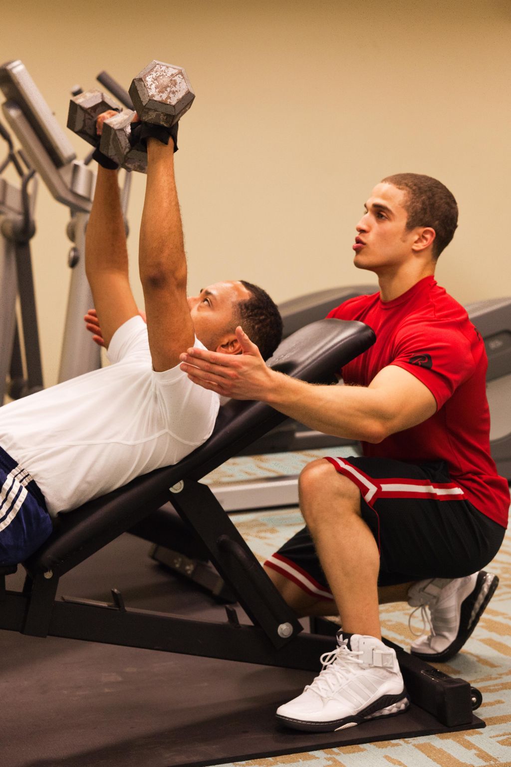 A photo of me spotting a client doing an incline d