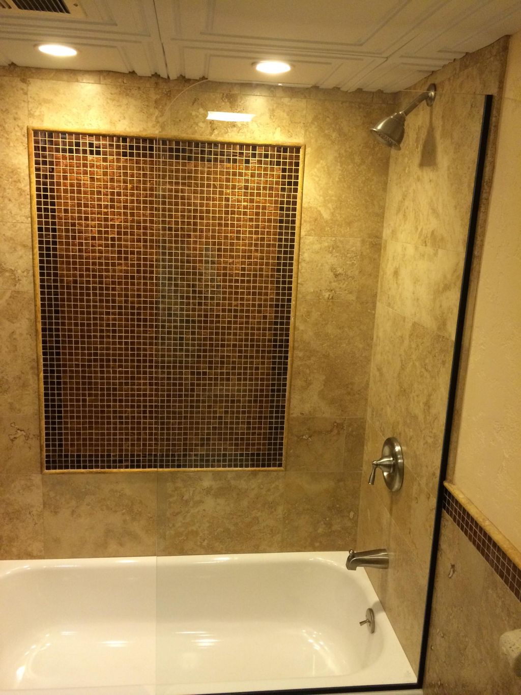 A standard travertine tub surround with glass inla