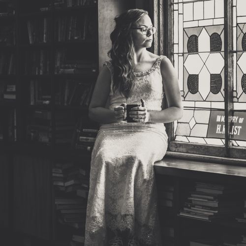 Portrait of bride musing on a stained glass window
