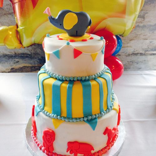 Circus-themed baby shower cake with gumpaste baby 