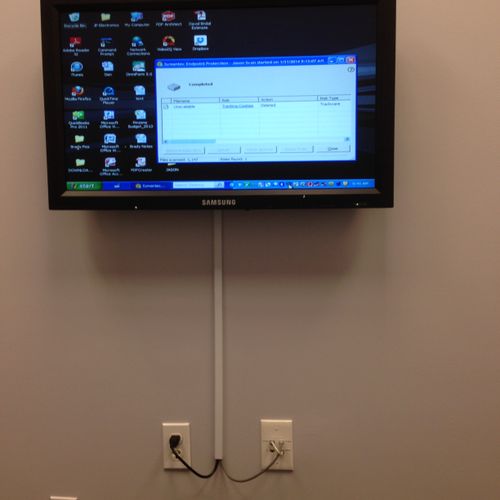 Conference room monitor mounted on wall with wire 