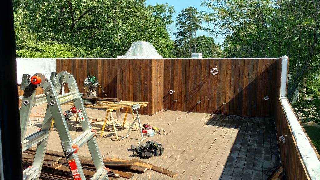 Vert. charred wood siding w/bamboo composite deck.