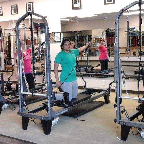 Clients using Pilates Tower/Reformer