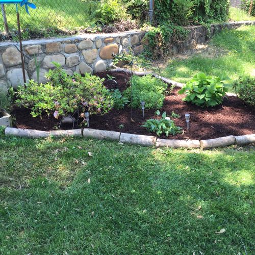 Diverse plants, new mulch, and creative edging.