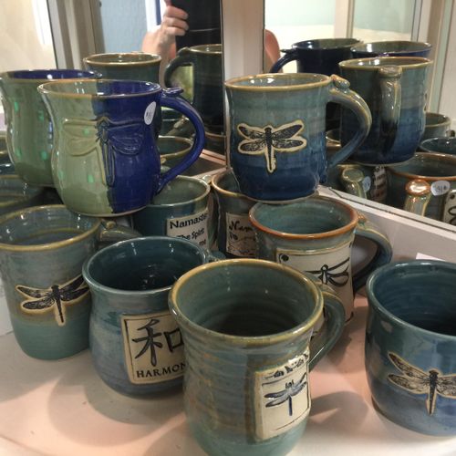 Dragonfly and Yoga themed mugs made by local potte