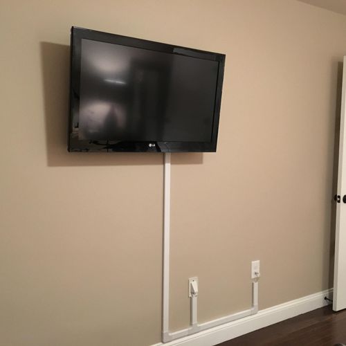 TV mounted on bedroom wall and using wire mold