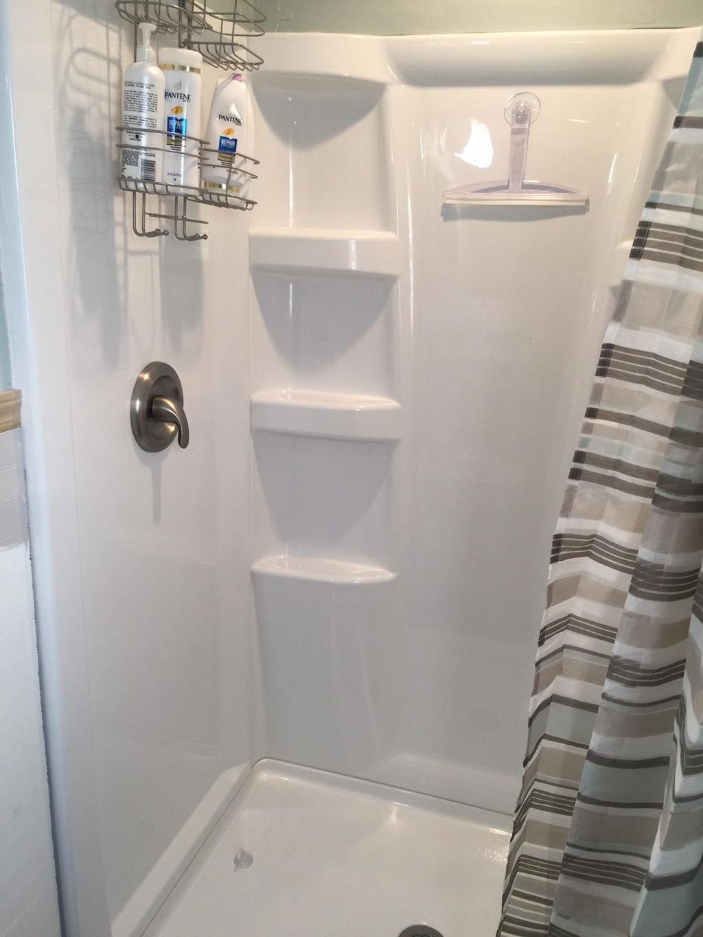 Shower wall set with pan installed, installed bras