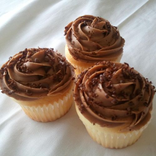 Chocolate frosted vanilla cupcakes with chocolate 