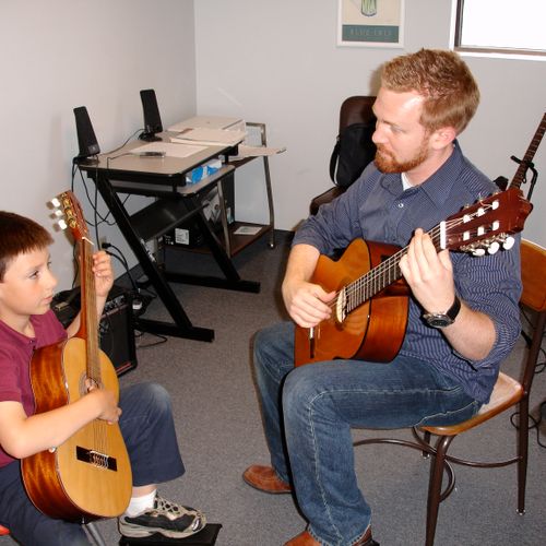 During Suzuki guitar lessons the student and teach