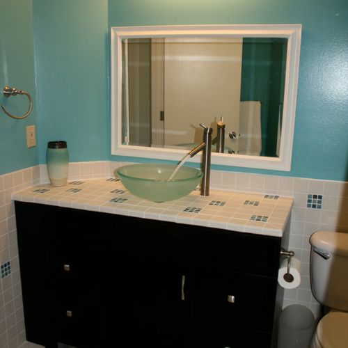 A bathroom remodel with a customized vanity and mi