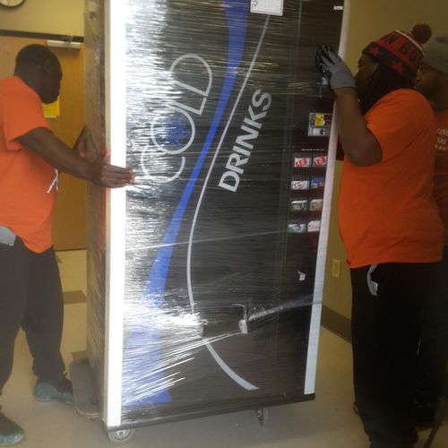 Placing the vending machine into its location in t