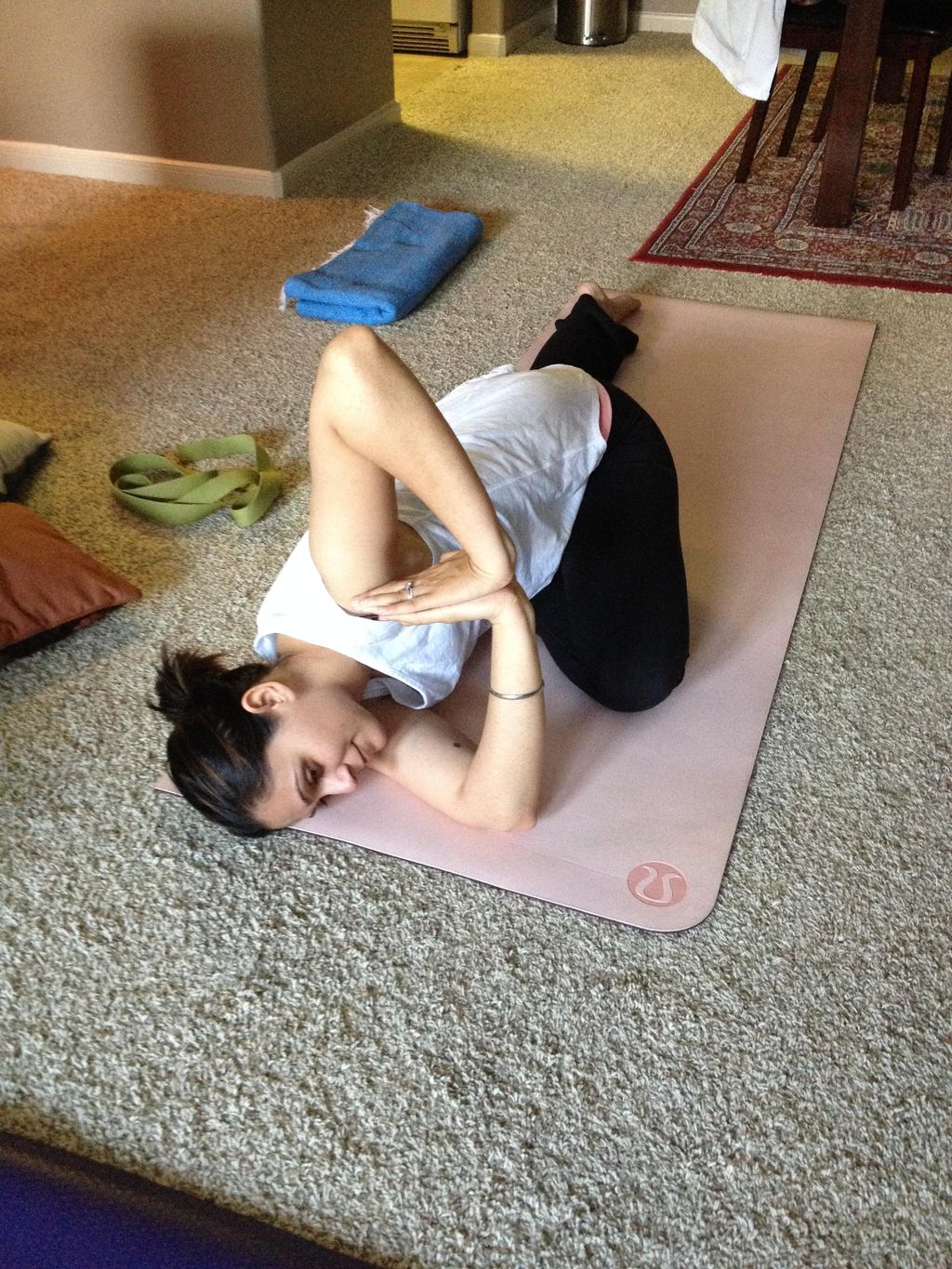 A client in Pigeon Pose twist.