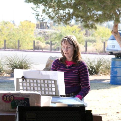 Ms Debbie Singing and playing keys at the park.  E