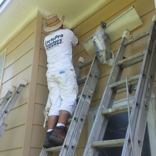 Masking and painting exterior siding.