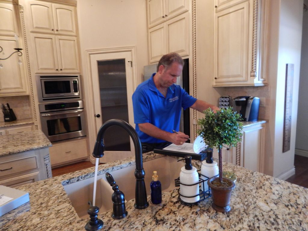 Tim H. inspecting built in items in kitchen, stove