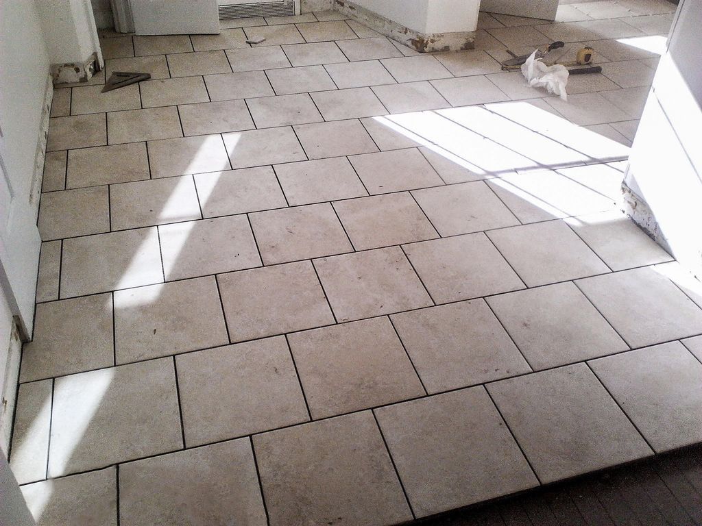 All new tile floor installed over existing hard wo