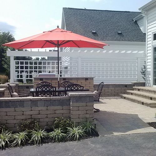 This New Albany paver patio features a privacy tre