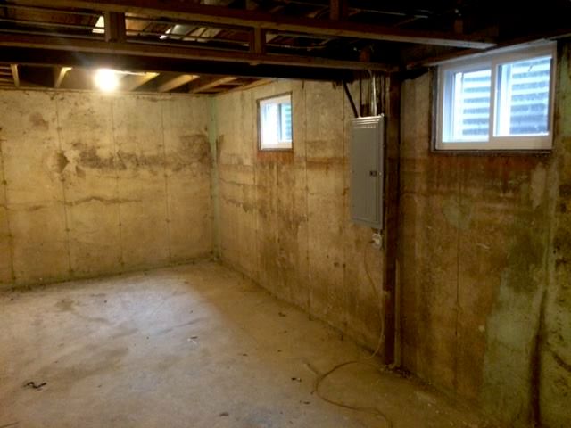 Before: basement mold growth on concrete walls and