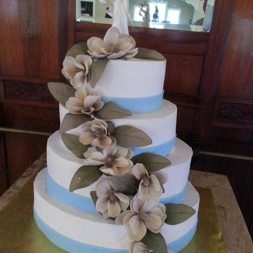 4 tier Buttercream iced with silk floral design