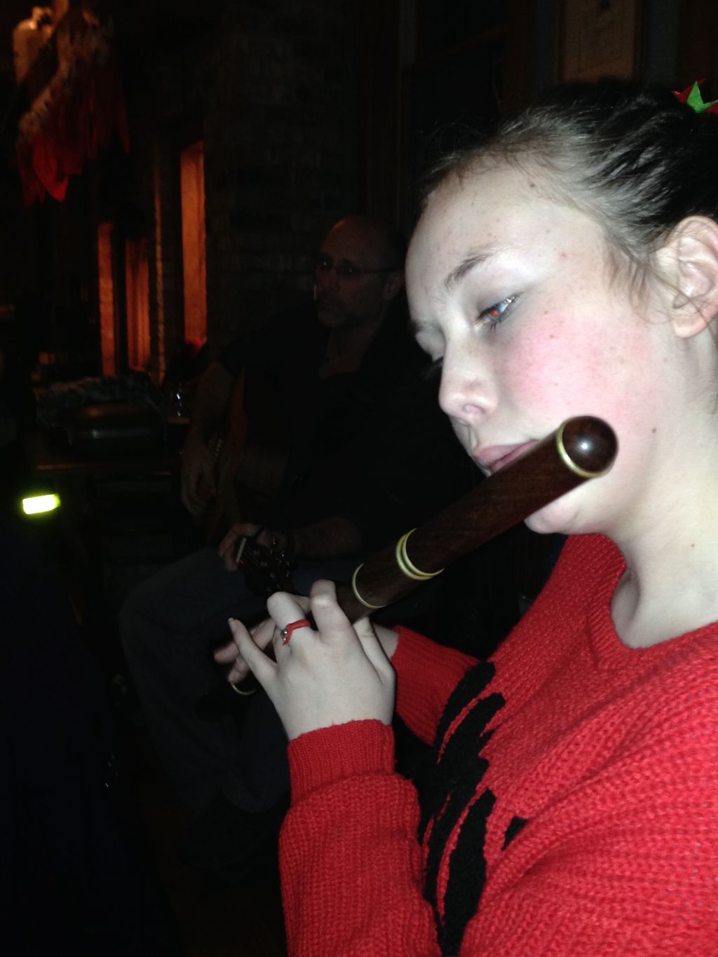 Maura is playing a traditional Irish flute made fr