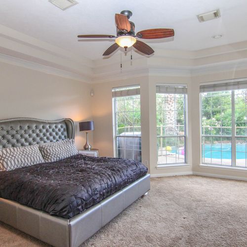 Beautiful master bedroom with a view of the pool!