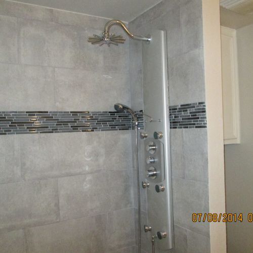 Shower remodel.
Tile wall covering with accent bor
