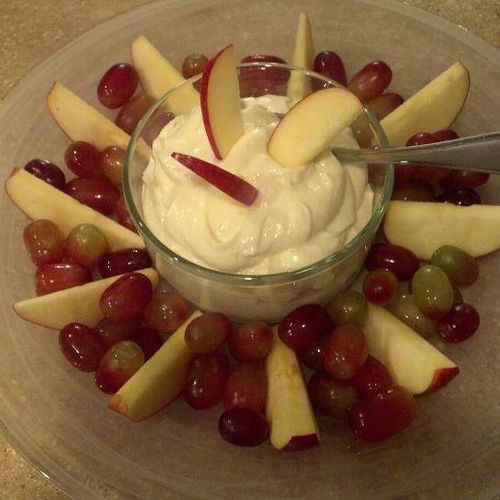 Sliced apples and grapes with homemade sweet dippi