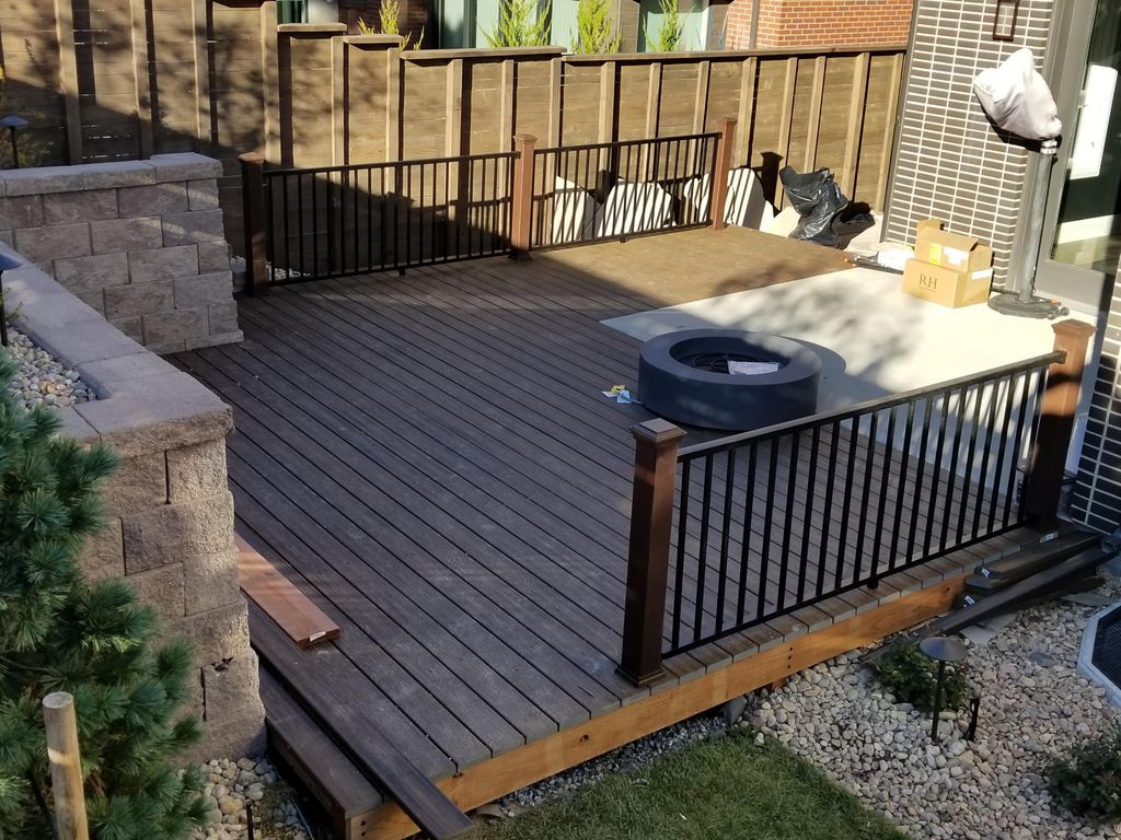 Trex deck with railings and gas fireplace.