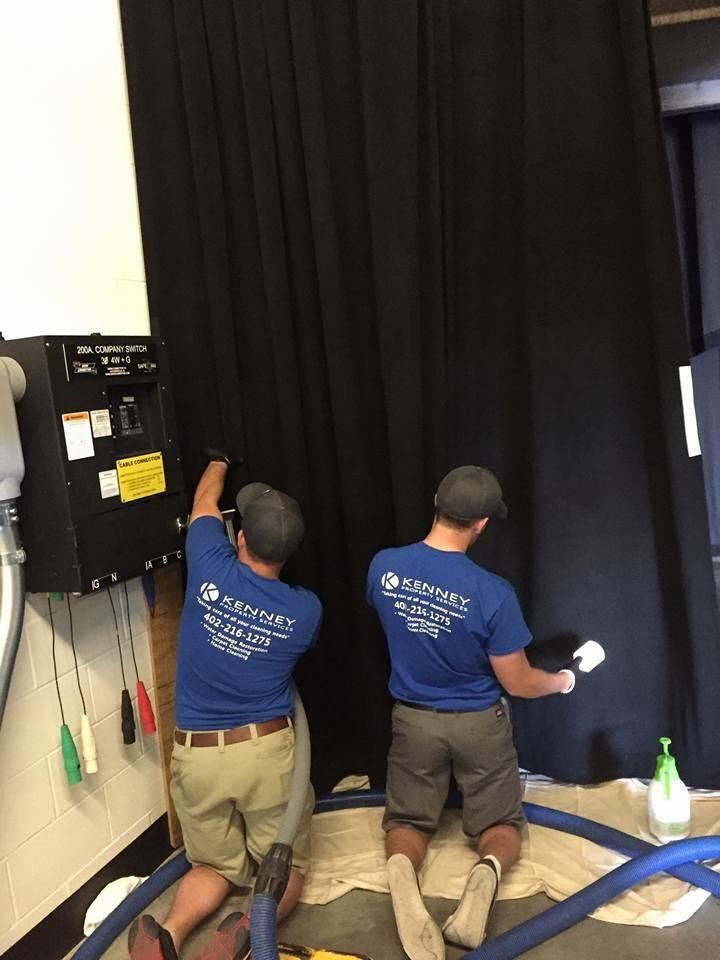 Jake and John cleaning curtains at Omaha's Baxter 