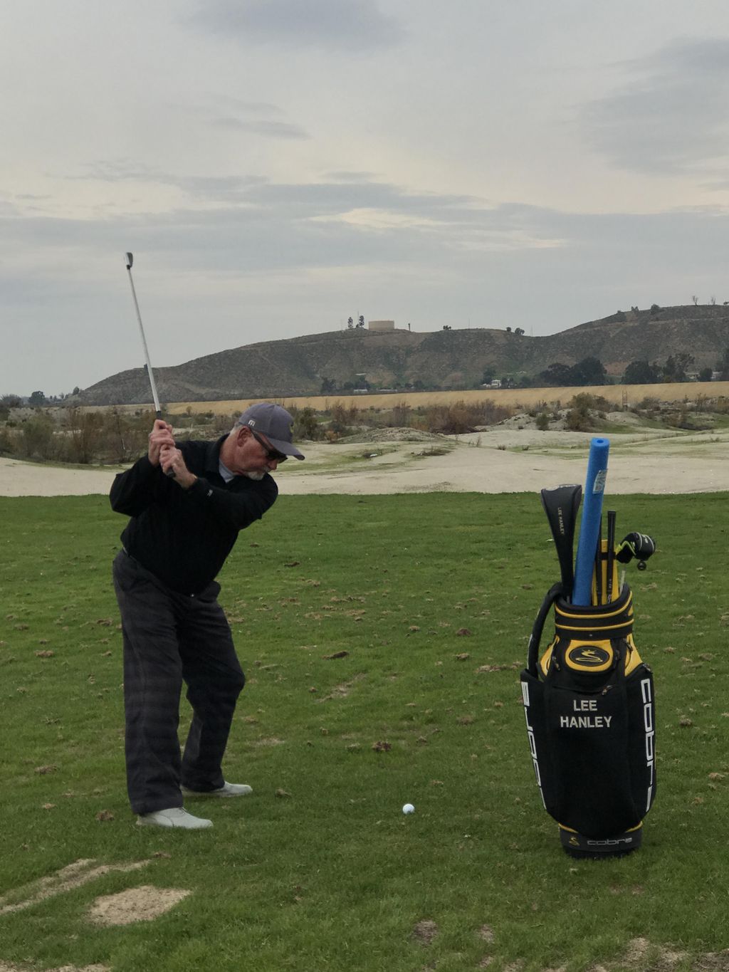 hitting off the natural grass turf on the driving 