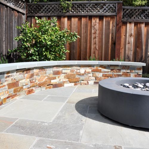Natural stone patio with sitting wall.